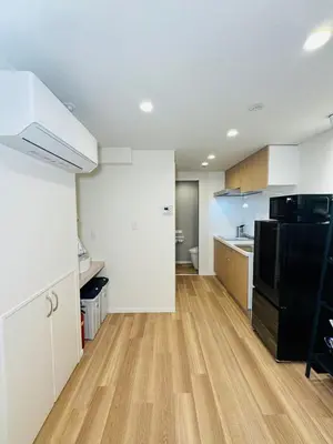 a kitchen with a black refrigerator and a wooden floor at Senzoku, Taito City 201-TT0306 in Tokyo