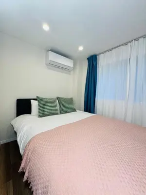 a bedroom with a large bed and a window at Senzoku, Taito City 201-TT0306 in Tokyo