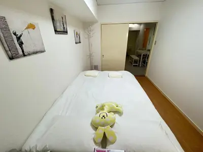 a room with a bed with a teddy bear on it at Ikebukuro\u4e2d\u5ddd4D-TS0035 in Tokyo