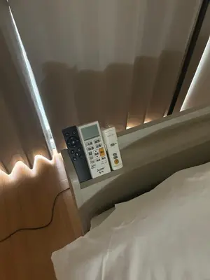 a hotel room with a bed and a remote control at Ikebukuro\u4e2d\u5ddd4D-TS0035 in Tokyo