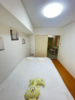 a bedroom with a bed with a teddy bear on it at Ikebukuro\u4e2d\u5ddd4D-TS0035 in Tokyo