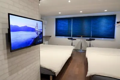 a bedroom with two beds and a flat screen tv at WonderfulStayTOKYO Asakusa - Vacation STAY 68456v in Tokyo