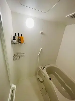 a bathroom with a tub and a light on the wall at WonderfulStayTOKYO Asakusa - Vacation STAY 68456v in Tokyo