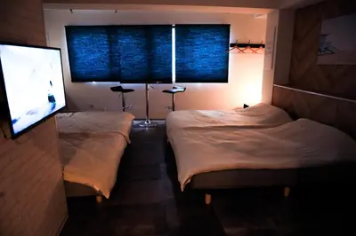 two beds in a room with a window and a mirror at WonderfulStayTOKYO Asakusa - Vacation STAY 68233v in Tokyo