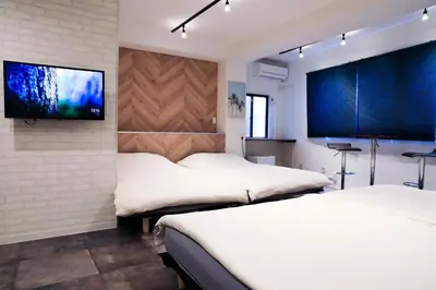 a bedroom with two beds and a flat screen tv at WonderfulStayTOKYO Asakusa - Vacation STAY 68233v in Tokyo