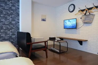 a bedroom with a desk and a tv on a wall at WonderfulStayTOKYO Asakusa - Vacation STAY 68472v in Tokyo