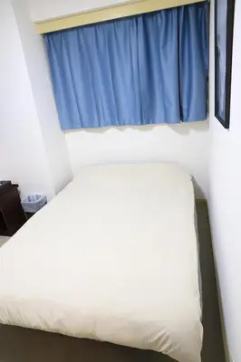 a bed in a room with a blue window at Wonderful stay TOKYO Asakusa - Vacation STAY 96514v in Tokyo