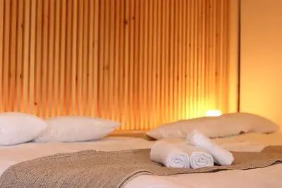 a bed with two pillows and two towels on it at Sun Mall Crest 506 - Vacation STAY 19930 in Tokyo