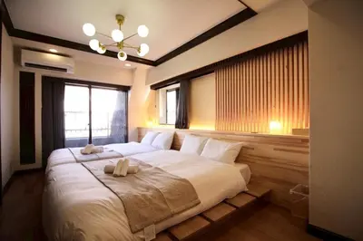 a bedroom with a large bed with two towels on it at Sun Mall Crest 506 - Vacation STAY 19930 in Tokyo