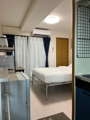 a hospital room with a bed and a kitchen at CraftFlat Numabukuro 302, uphill residence in Tokyo