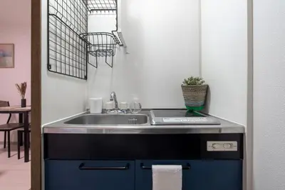 a kitchen with a sink and a counter top at CraftFlat Numabukuro 302, uphill residence in Tokyo