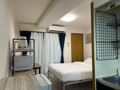 a small room with a bed and a sink at CraftFlat Numabukuro 302, uphill residence in Tokyo