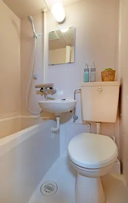 a white bathroom with a toilet and a sink at CraftFlat Numabukuro 302, uphill residence in Tokyo