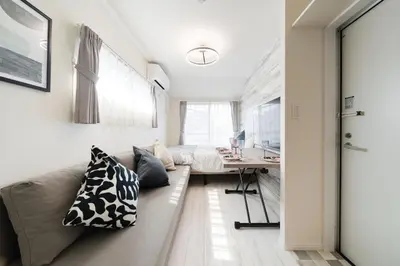 a living room with a couch and a desk at Intervia Horikiri in Tokyo