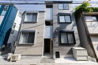 an apartment building with two appliances in front of it at Intervia Horikiri in Tokyo