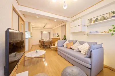 a living room with a couch and a dining room at Near Ueno House 7min Honkomagome 9min Sendagi in Tokyo