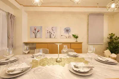 a dining room table with plates and wine glasses at Near Ueno House 7min Honkomagome 9min Sendagi in Tokyo