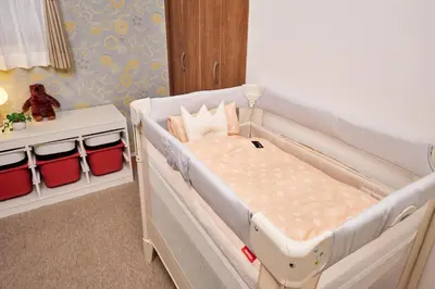 a white bed in a room with a crib at Near Ueno House 7min Honkomagome 9min Sendagi in Tokyo