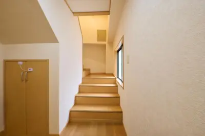 a hallway with stairs with a window and a door at Near Ueno House 7min Honkomagome 9min Sendagi in Tokyo