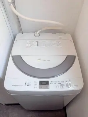 a washing machine with a cord on top of it at Ueno358 in Tokyo