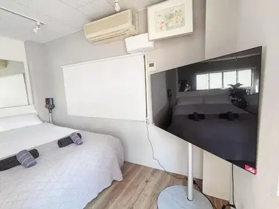 a bedroom with two beds and a large window at Ueno358 in Tokyo