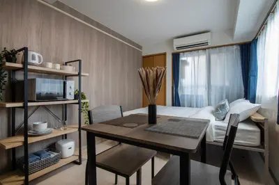 a small room with a table and a bed at CraftFlat Numabukuro 305, uphill residence in Tokyo