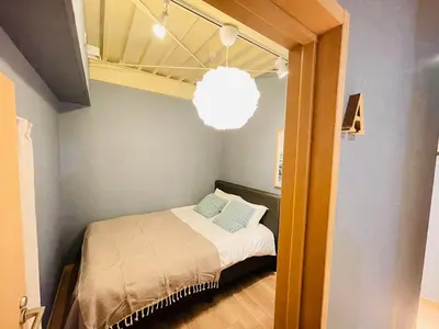 a small bedroom with a bed and a chandelier at Taito City, Higashiasakusa-3F-TT0304 in Tokyo