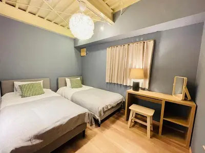 two beds in a room with a desk and a chair at Taito City, Higashiasakusa-3F-TT0304 in Tokyo