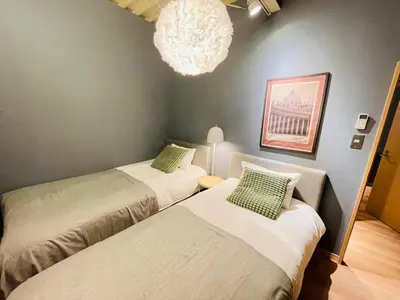 two beds in a room with a chandelier at Taito City, Higashiasakusa-3F-TT0304 in Tokyo