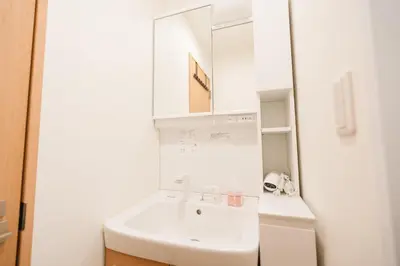 a white bathroom with a sink and a mirror at m1 \u30db\u30c6\u30eb in Tokyo