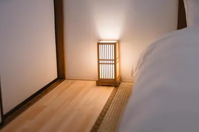 a bedroom with a bed and a small room with a door at m1 \u30db\u30c6\u30eb in Tokyo