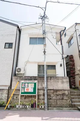a white building with a sign in front of it at m1 \u30db\u30c6\u30eb in Tokyo