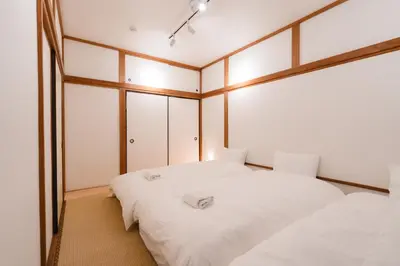 a bedroom with two beds and a mirror at m1 \u30db\u30c6\u30eb in Tokyo
