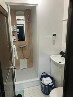a bathroom with a shower and a sink at Hanna Inn SHIBUYA 501 in Tokyo