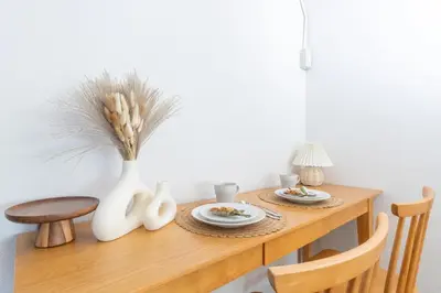 a table with two plates of food and a vase at Hanna Inn SHIBUYA 501 in Tokyo
