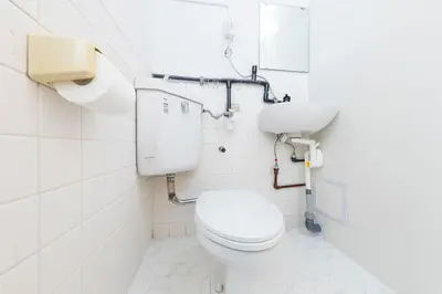 a bathroom with a toilet and a sink at Hanna Inn SHIBUYA 102 in Tokyo