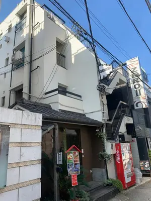 a building with a sign on the side of it at Hanna Inn SHIBUYA 102 in Tokyo