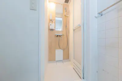 a bathroom with a shower and a walk in shower at Hanna Inn SHIBUYA 102 in Tokyo