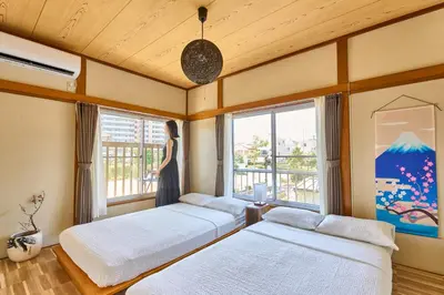 two beds in a room with two windows at Stay as Local mizue in Tokyo