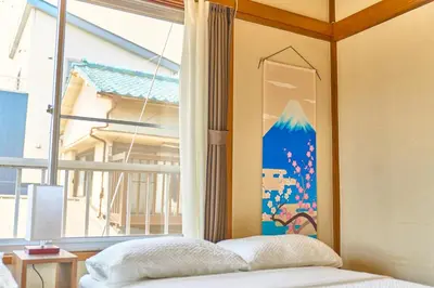 a bedroom with a bed and a large window at Stay as Local mizue in Tokyo