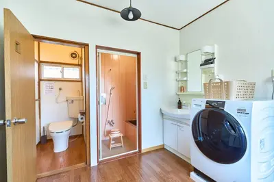 a small bathroom with a toilet and a tv in it at Stay as Local mizue in Tokyo
