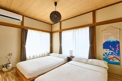 a bedroom with two beds and a window at Stay as Local mizue in Tokyo