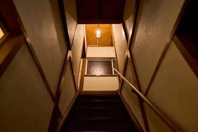 a flight of stairs with a light at the top at Stay as Local mizue in Tokyo