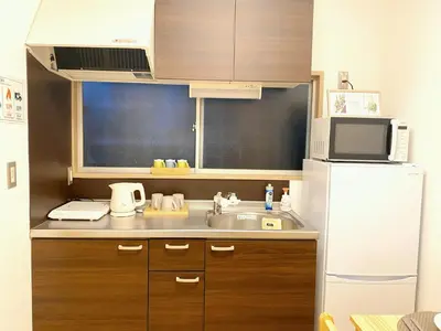 a small kitchen with a sink and a refrigerator at Mori Hotel \u897f\u6c60\u888b in Tokyo