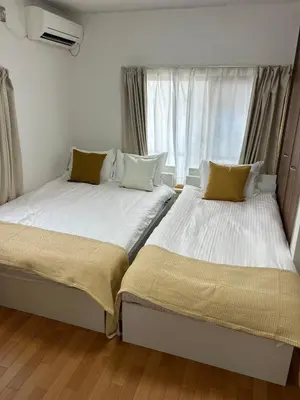 two beds sitting next to each other in a bedroom at Mori Hotel \u897f\u6c60\u888b in Tokyo