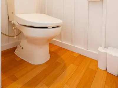 a white toilet in a bathroom with a wooden floor at Mori Hotel \u897f\u6c60\u888b in Tokyo