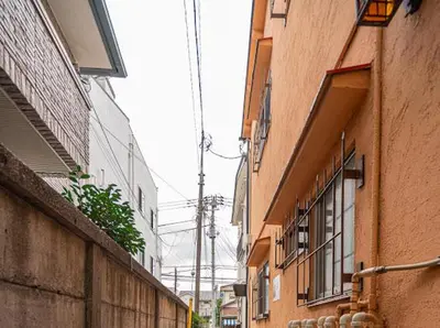 an alley between two buildings on a city street at Mori Hotel \u897f\u6c60\u888b in Tokyo