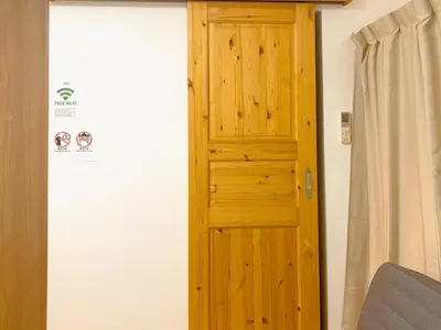 a wooden door in a room with a curtain at Mori Hotel \u897f\u6c60\u888b in Tokyo