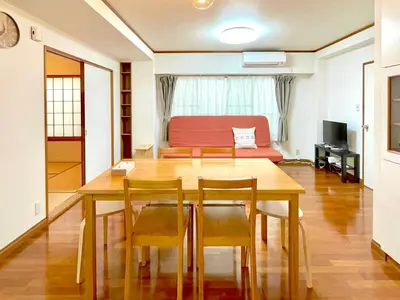 a dining room with a table and chairs and a couch at \u30a8\u30fc\u30c7\u30eb\u30ef\u30a4\u30b9 Edelweiss in Tokyo