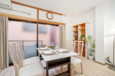 a dining room with a table and chairs at Mori House \u8d64\u7fbd\u4e00\u6237\u5efa in Tokyo